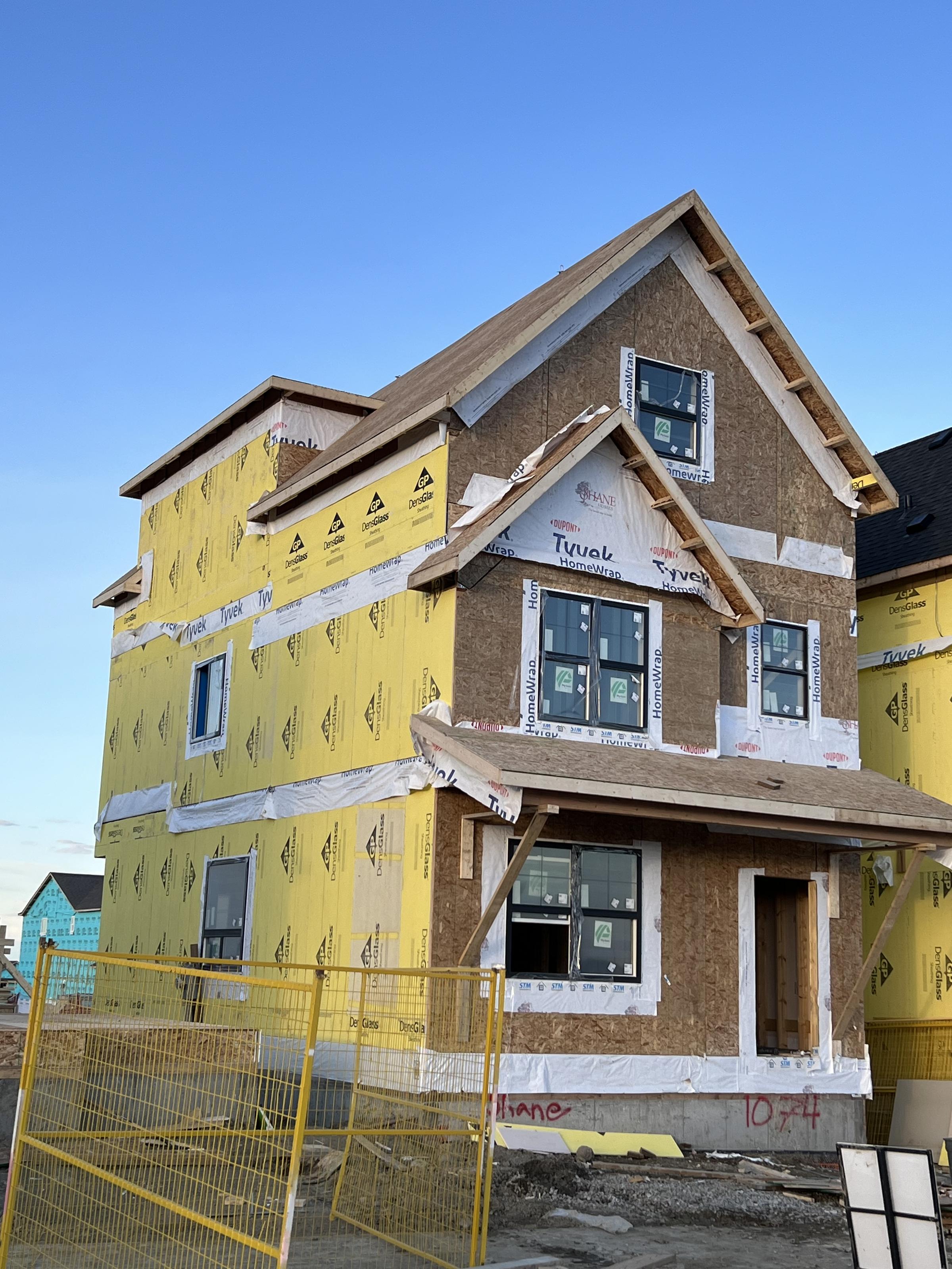 Framed home with gable ends sheathed and wrapped