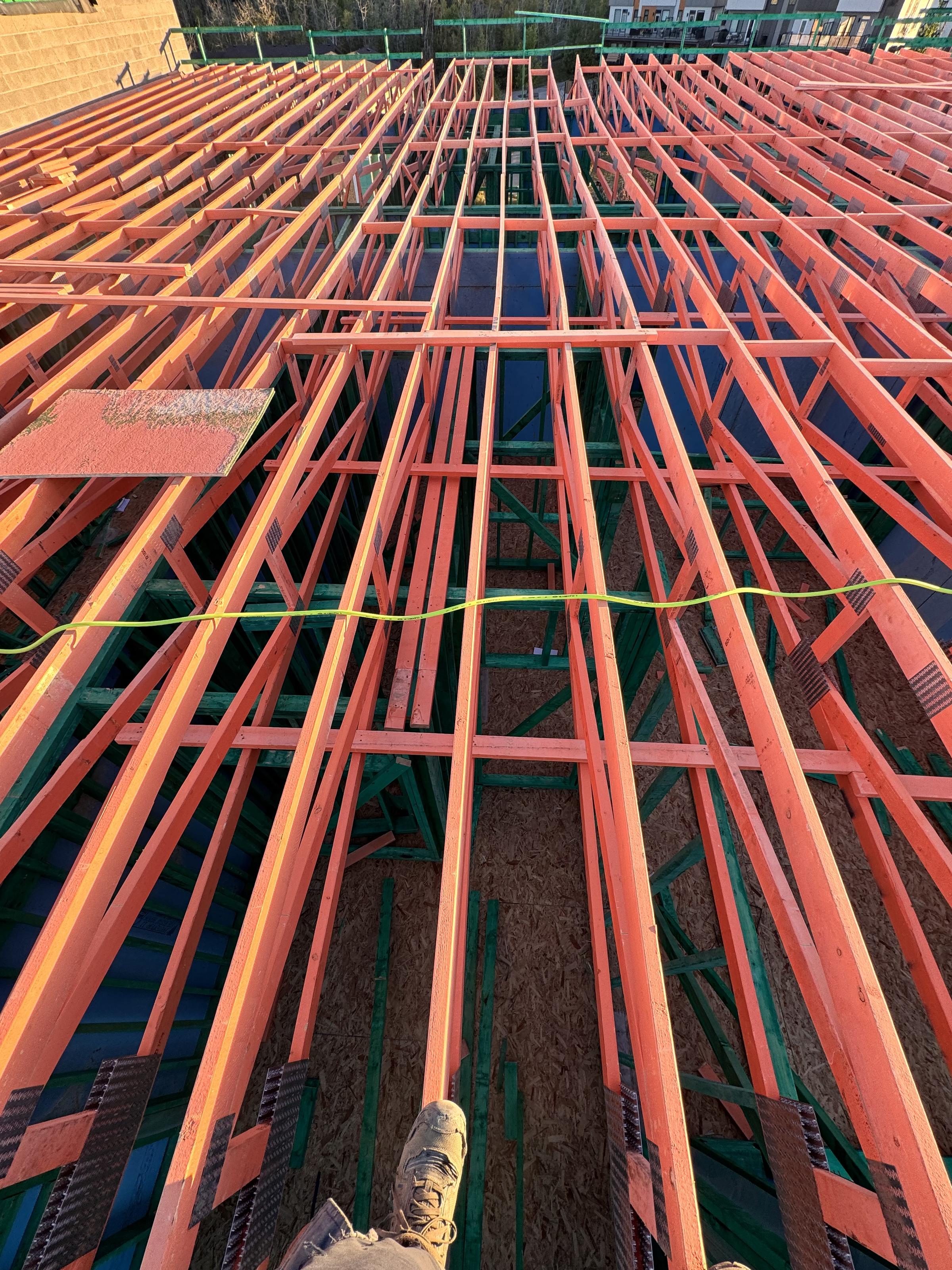 Engineered open-web floor joists installed across a deck