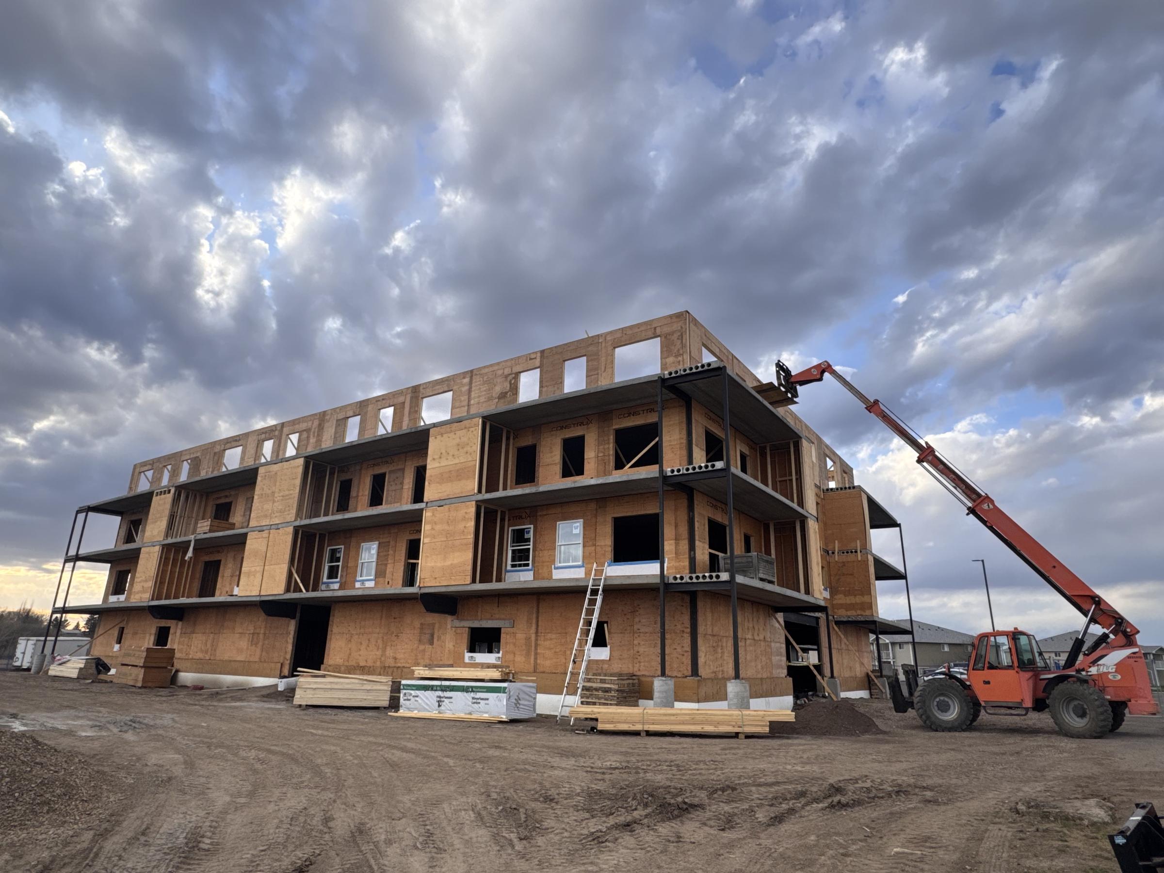 Multifamily wood-frame shell with telehandler