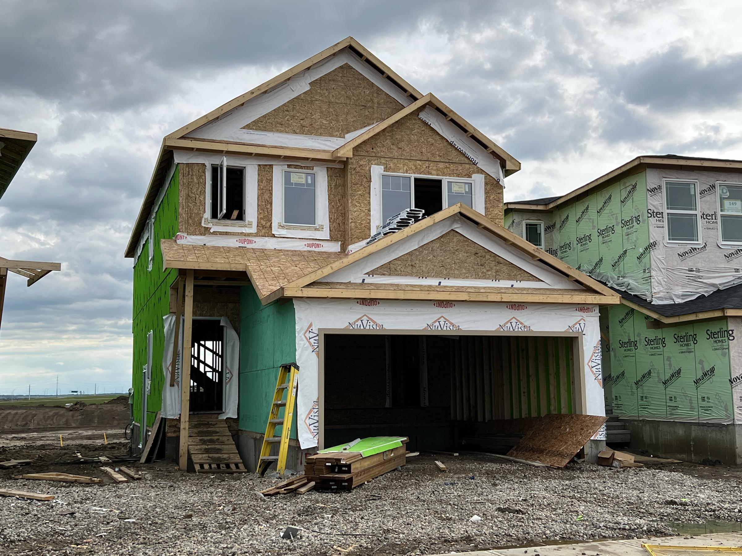 Single-family home framed and sheathed, gable end and garage opening visible