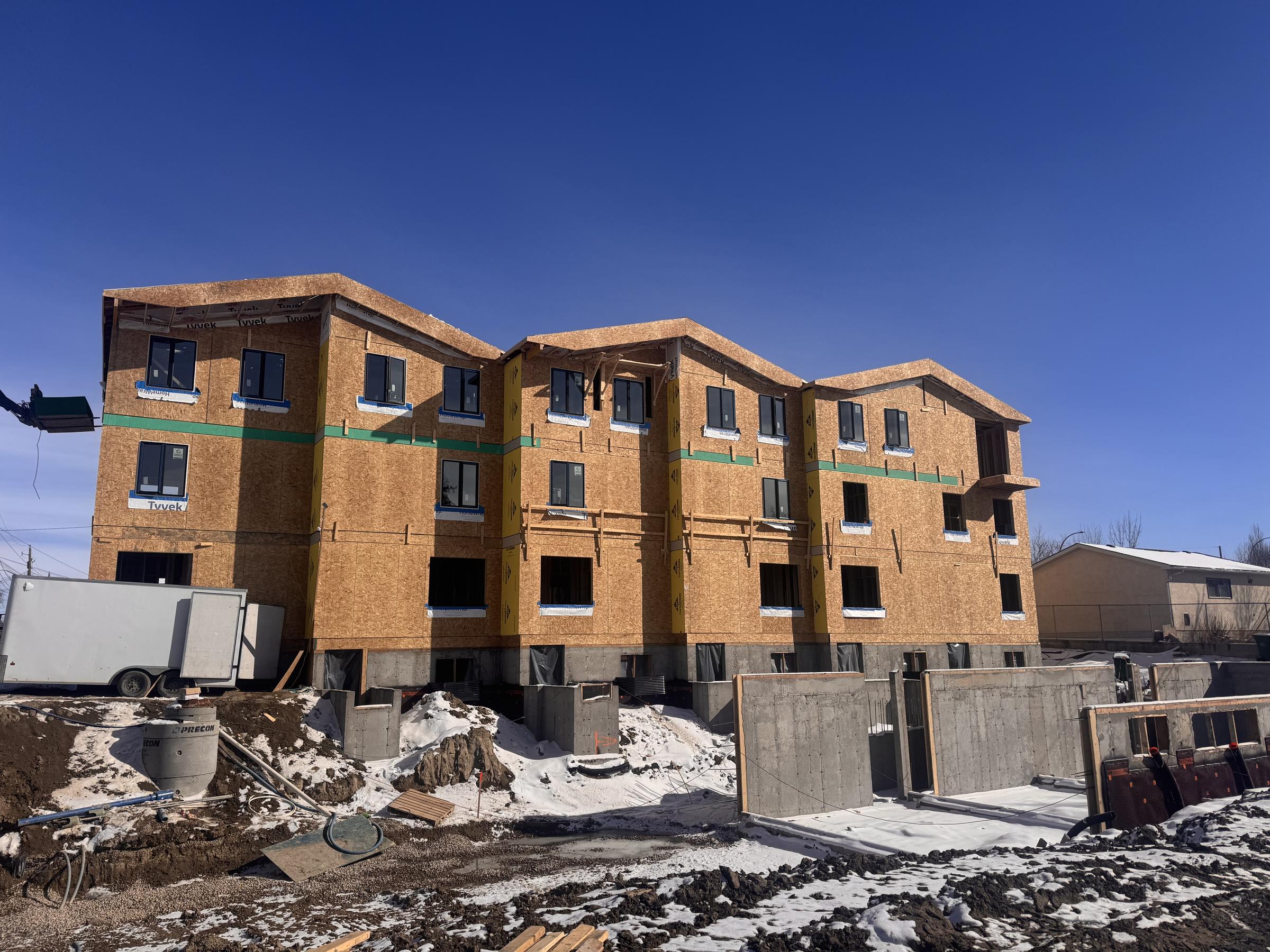 Framed townhomes on a winter site